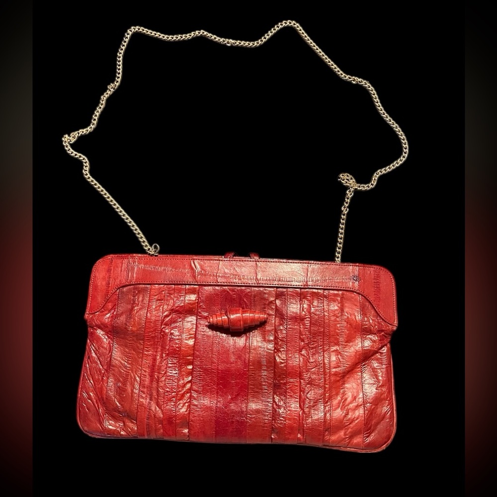 Vintage Eel Skin Purse with 21” Gold chain drop. Burgundy rust color.